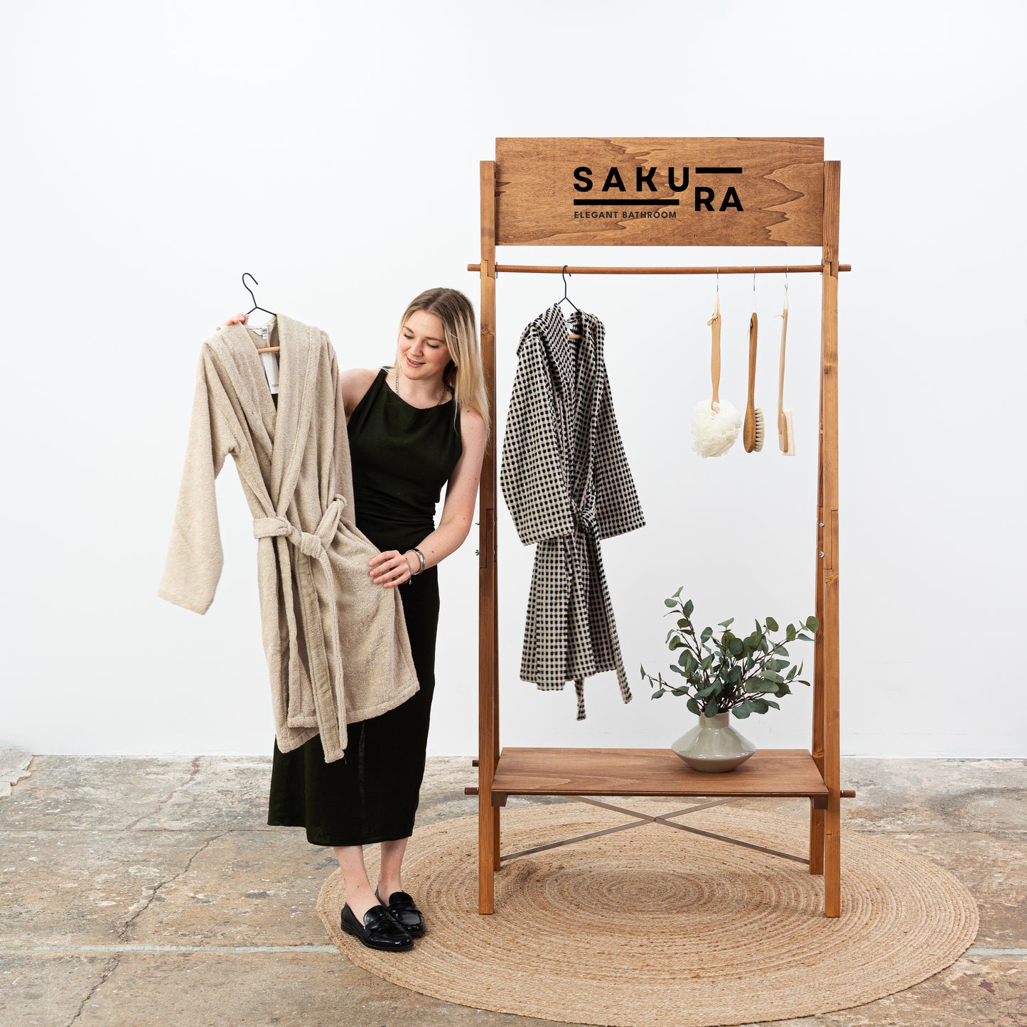 Elegant wooden retail rack showcasing spa-style robes and natural decor
