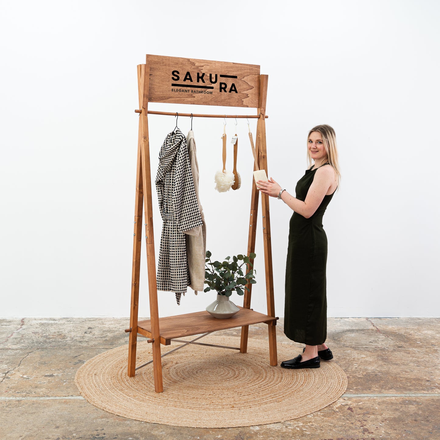 Foldable garment display stand with custom Sakura logo and lower shelf