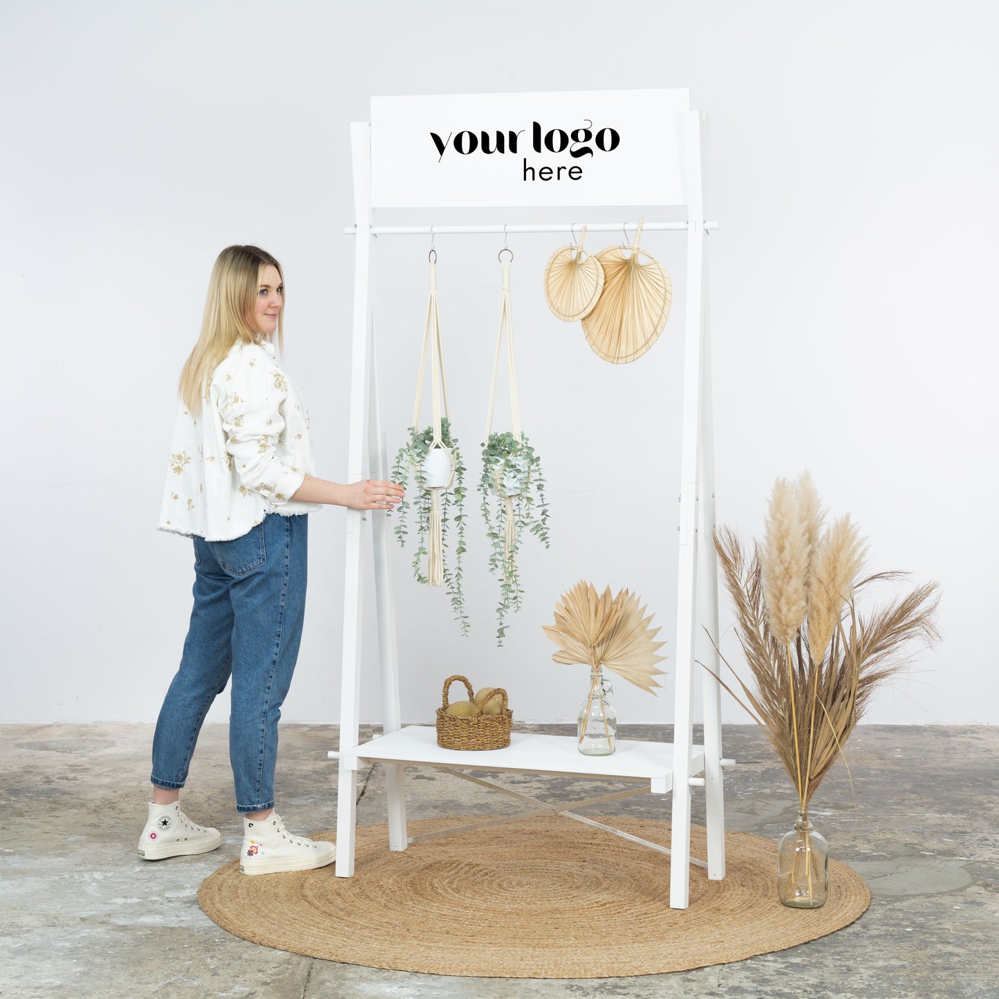 Bright retail setup with white wooden clothing rack