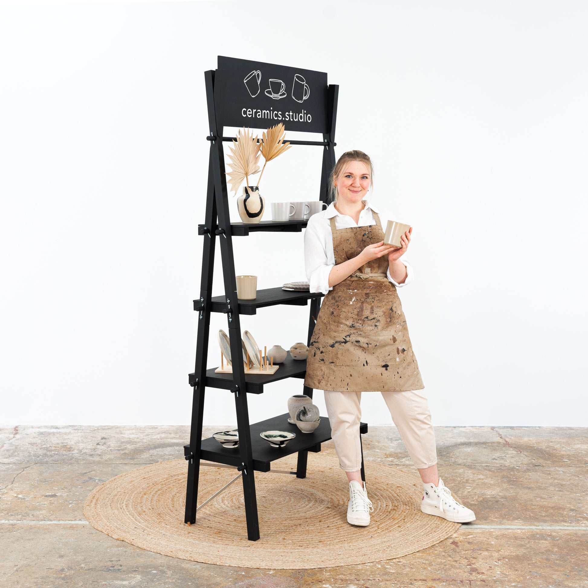 Black portable shelving display for boutiques, fashion stores, and corporate events