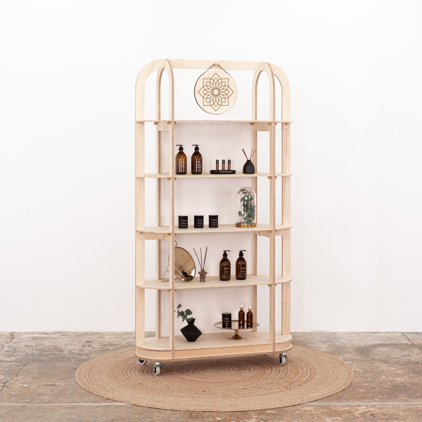 Minimal wooden exhibition shelf with glass bottles and decor