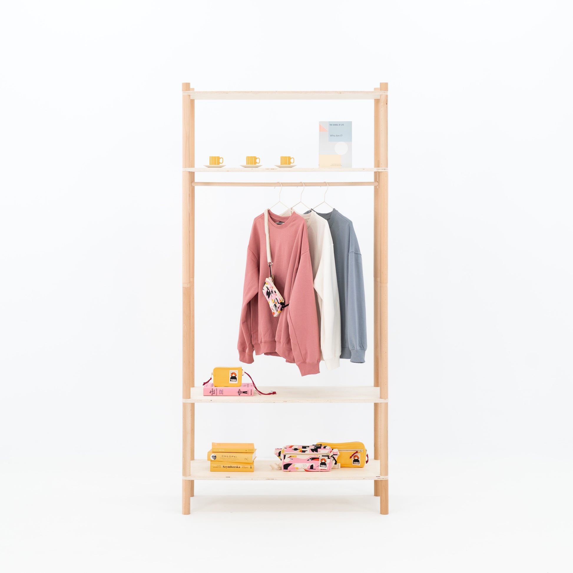 Double-sided BAMBUK garment rack with pink and gray clothes on hangers
