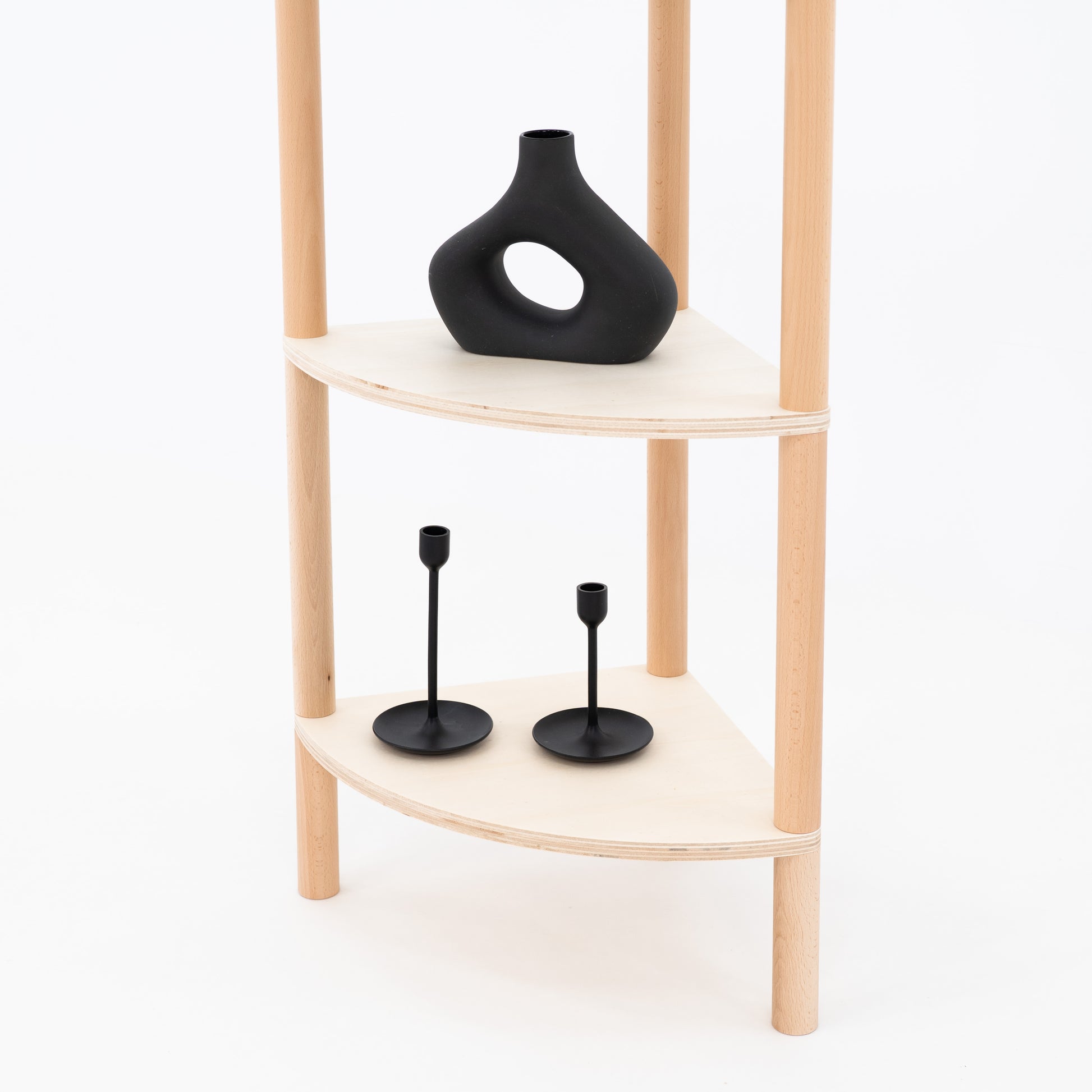 Open corner display shelf with black ceramic products