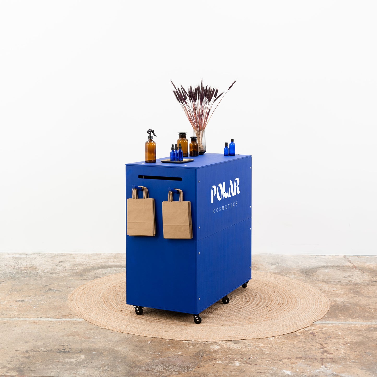 Navy blue mobile checkout counter with lockable wheels
