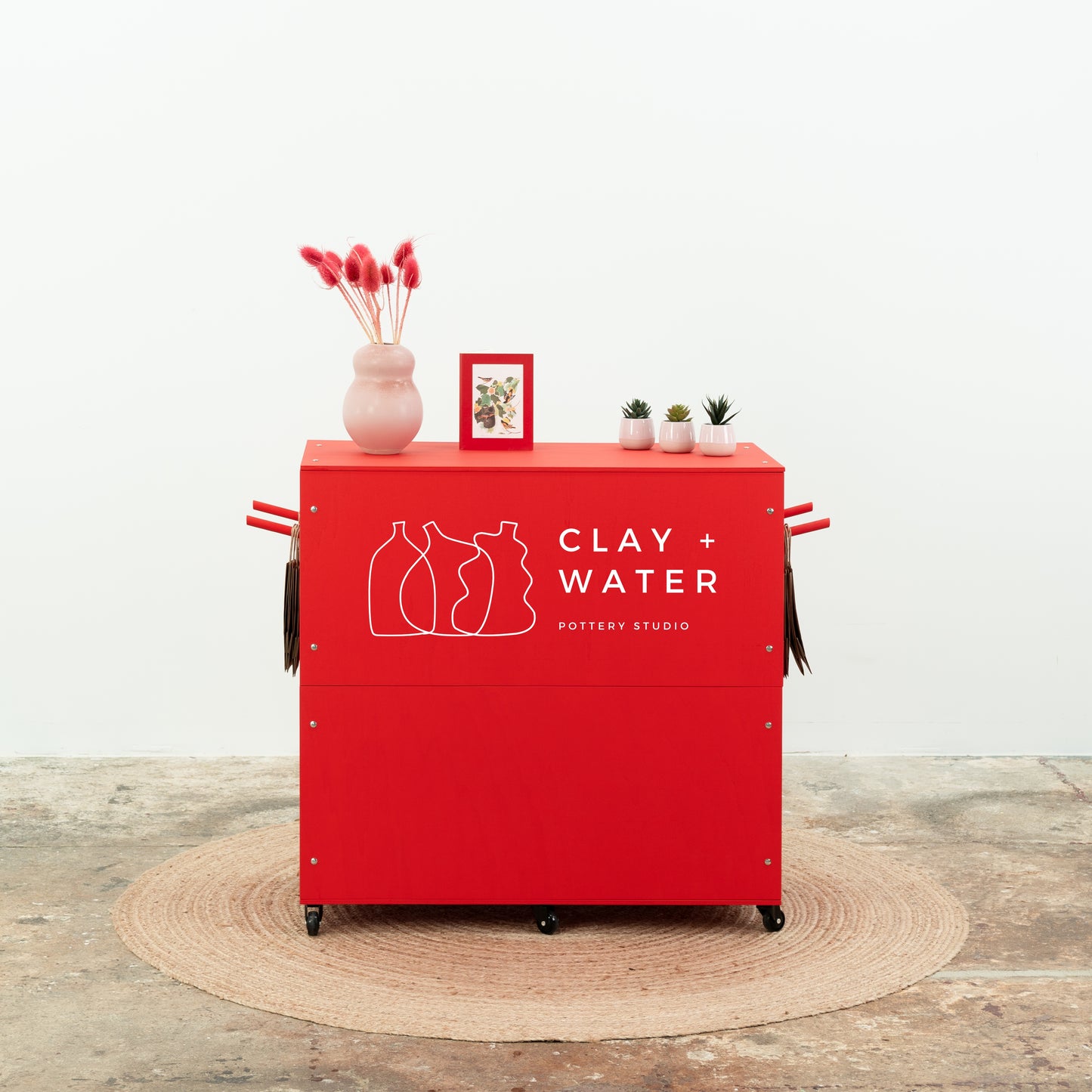 Red retail display counter with product accessories and branding