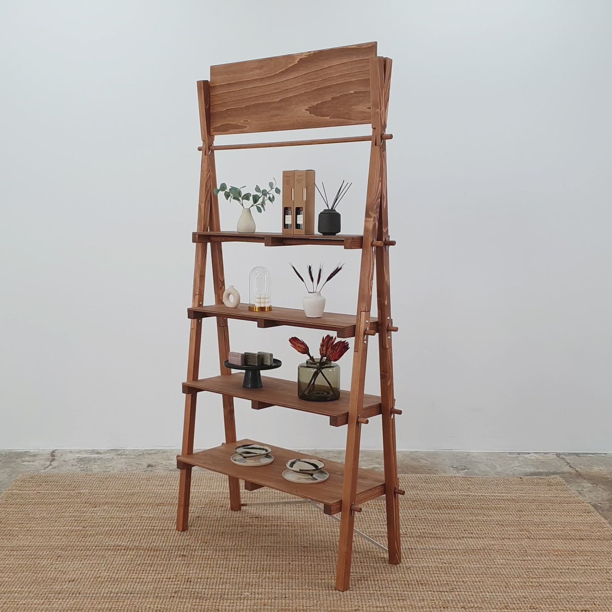 Product showcase of coffee-colored A-frame collapsible shelving unit in an artisan retail setting