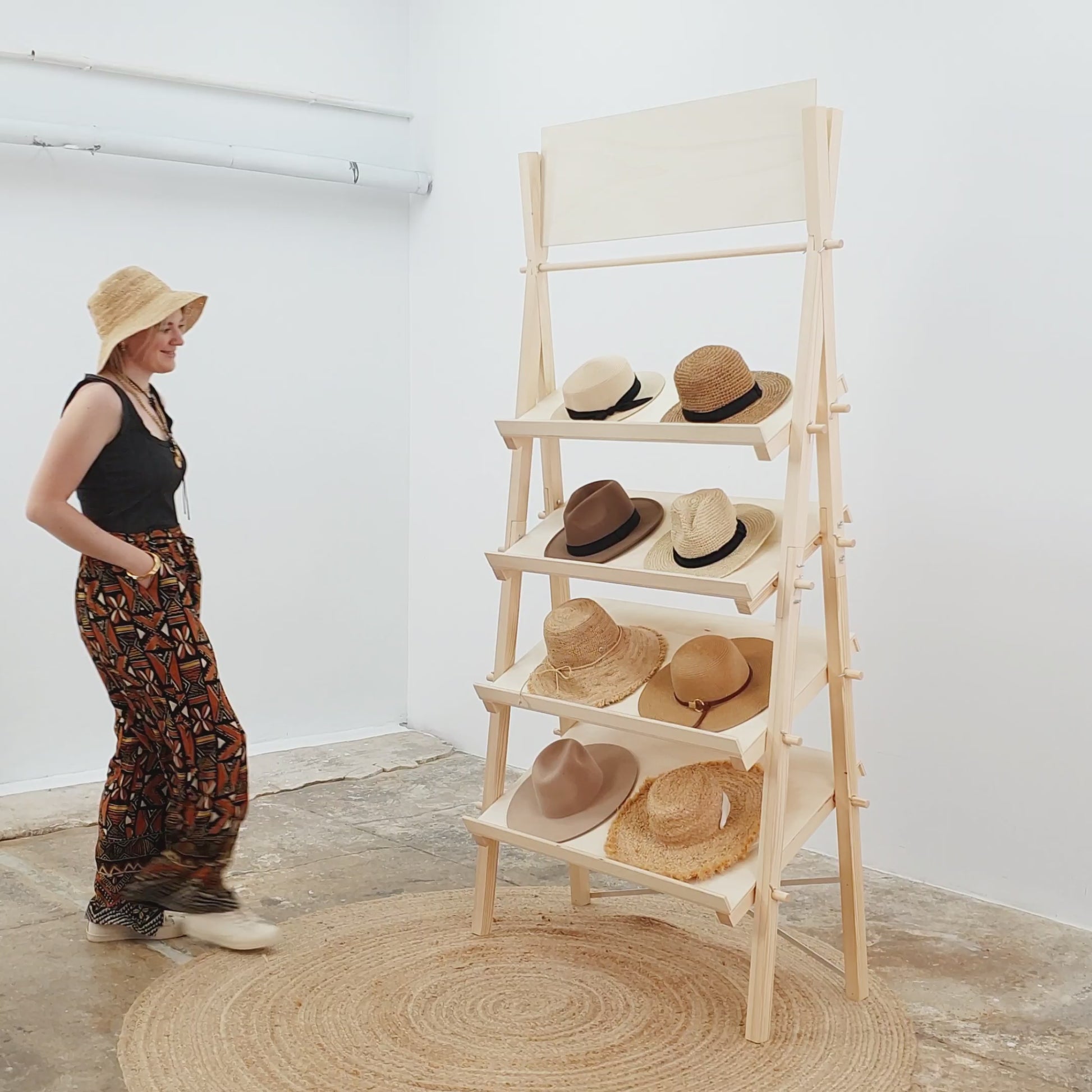 Video showing setup and styling of a natural wood A-frame shelf with home decor accessories for retail and events