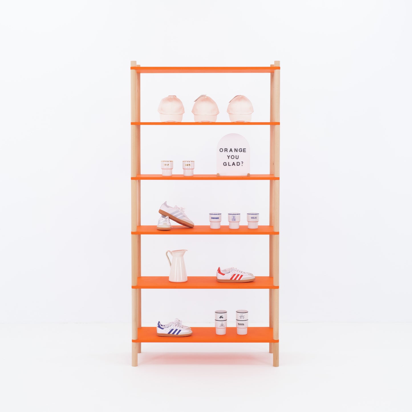Retail display shelf with orange shelves and cotton back panel