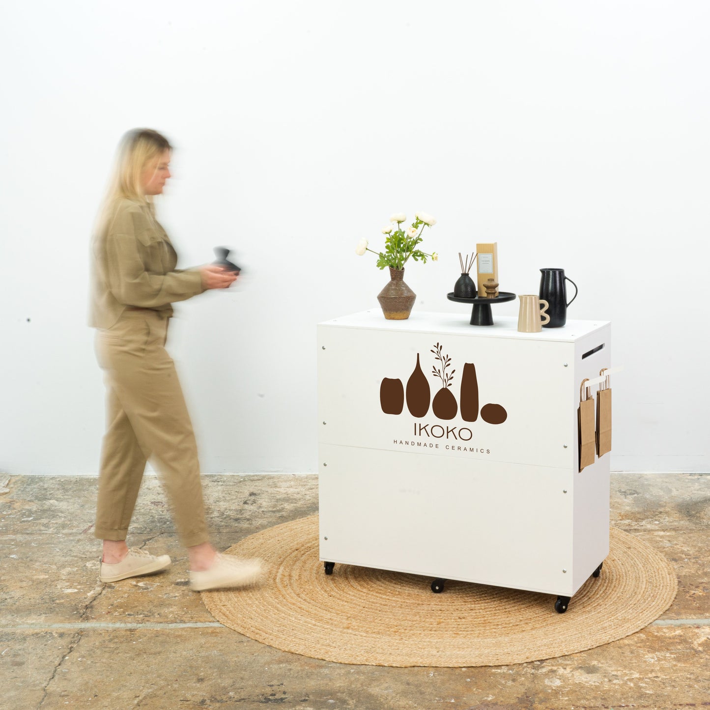 White checkout stand with storage space and branded panel