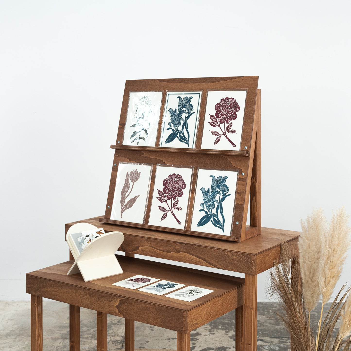 eco-friendly wooden stand showcasing journals and prints
