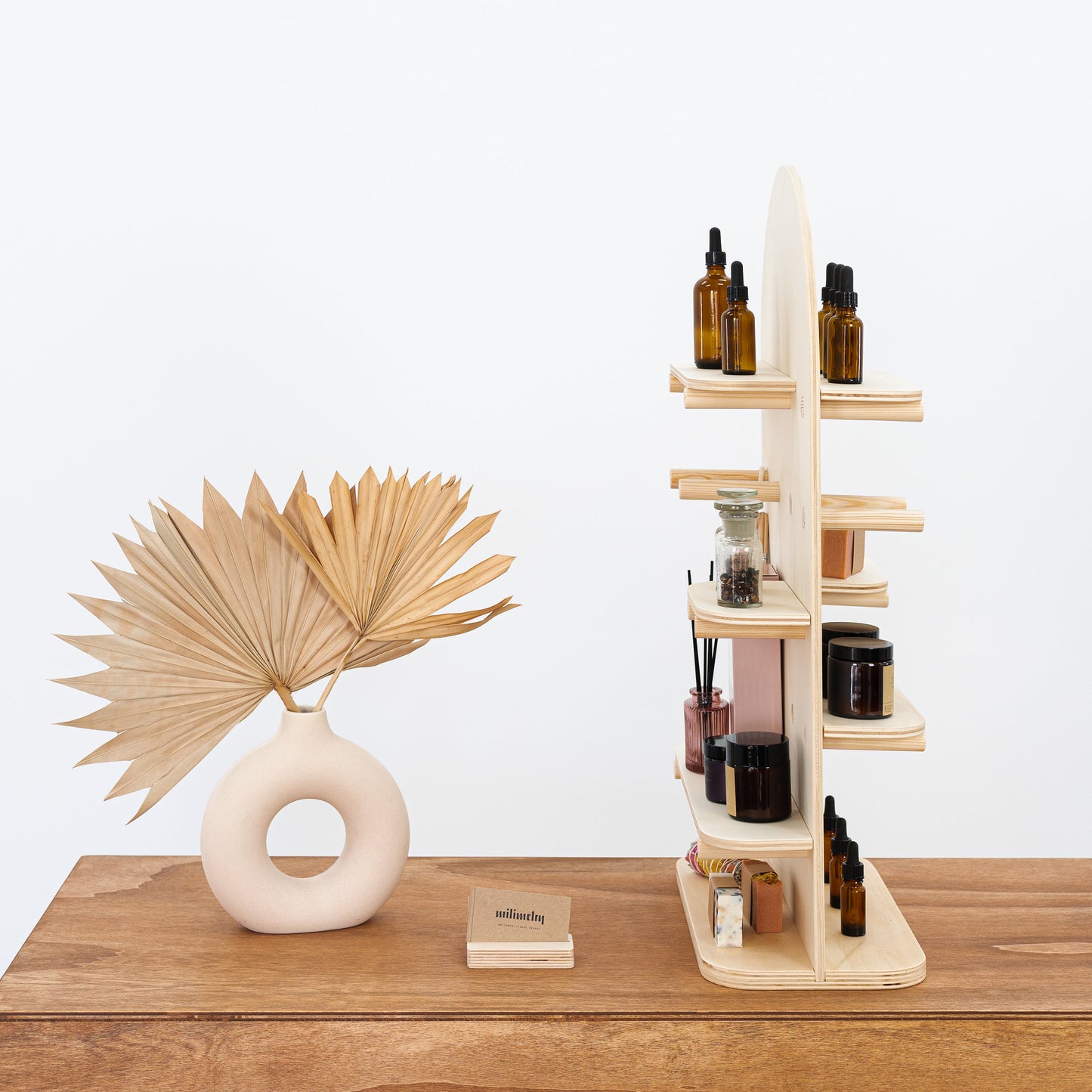 Natural wood tabletop display stand with shelves and pegs