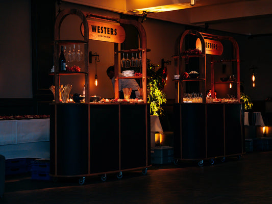 Row of dark branded carts at a Christmas evening event