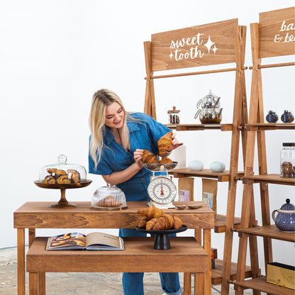 Nesting tables and branded shelf unit for event retail space