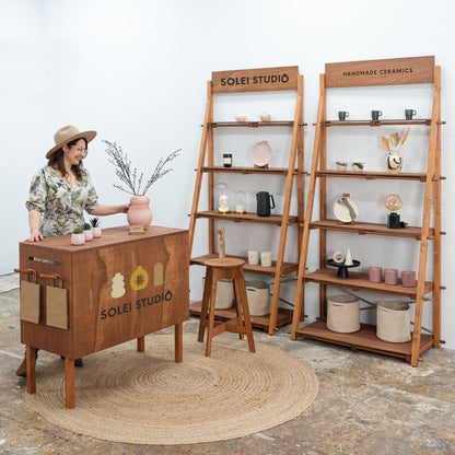 Complete coffee wood booth setup with shelving and counter

