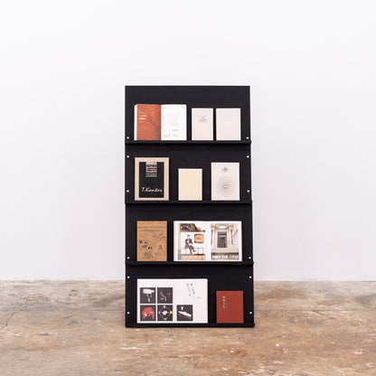 Matte black portable shelving unit filled with fashion magazines