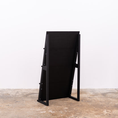 Two-part matte black shelf used for showcasing prints