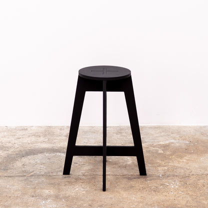 Minimalist matte black bar stool folded for transport