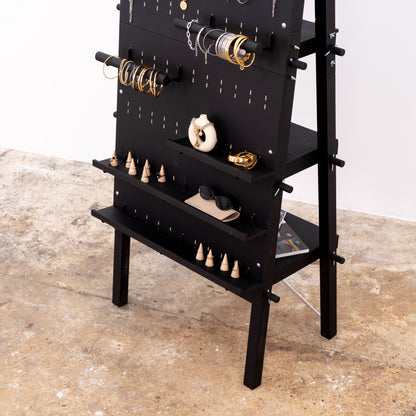 Jewelry and accessories arranged on modular pegboard system
