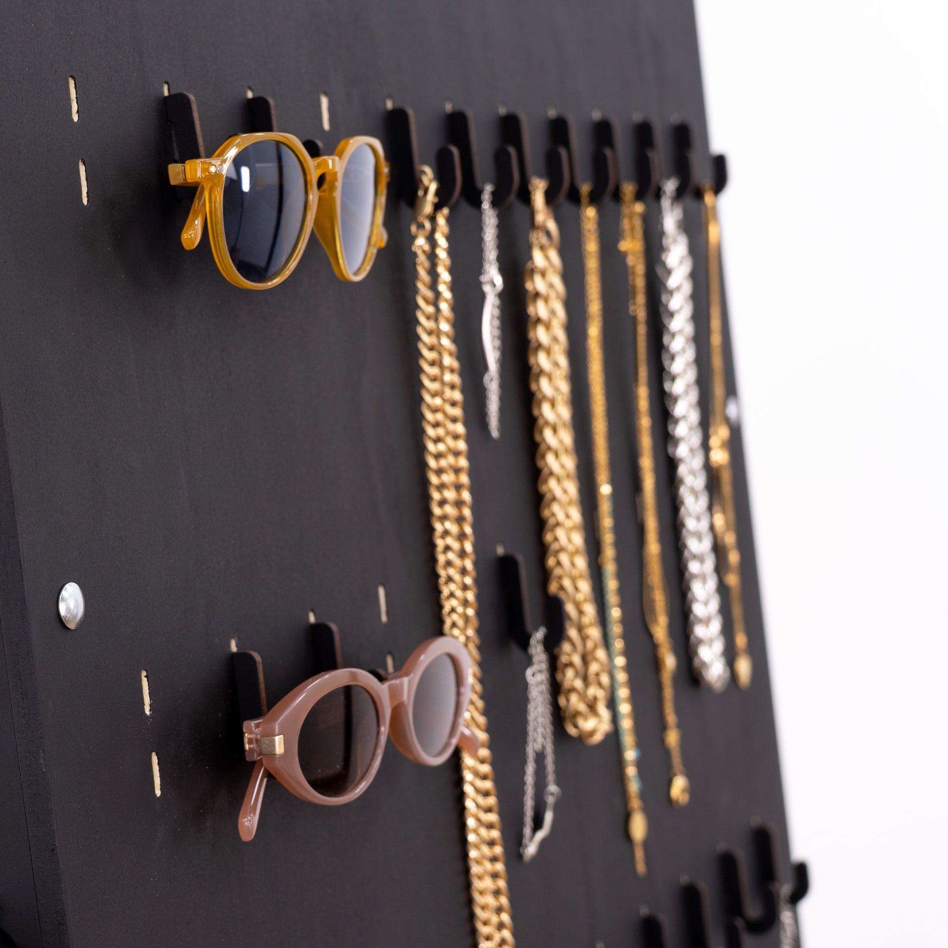 Wooden short hooks in black, designed to display small products on pegboards for a clean and modern retail setup.