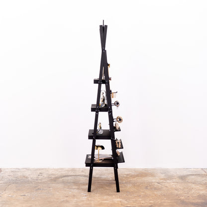 Portable black pegboard rack with minimalist layout and products
