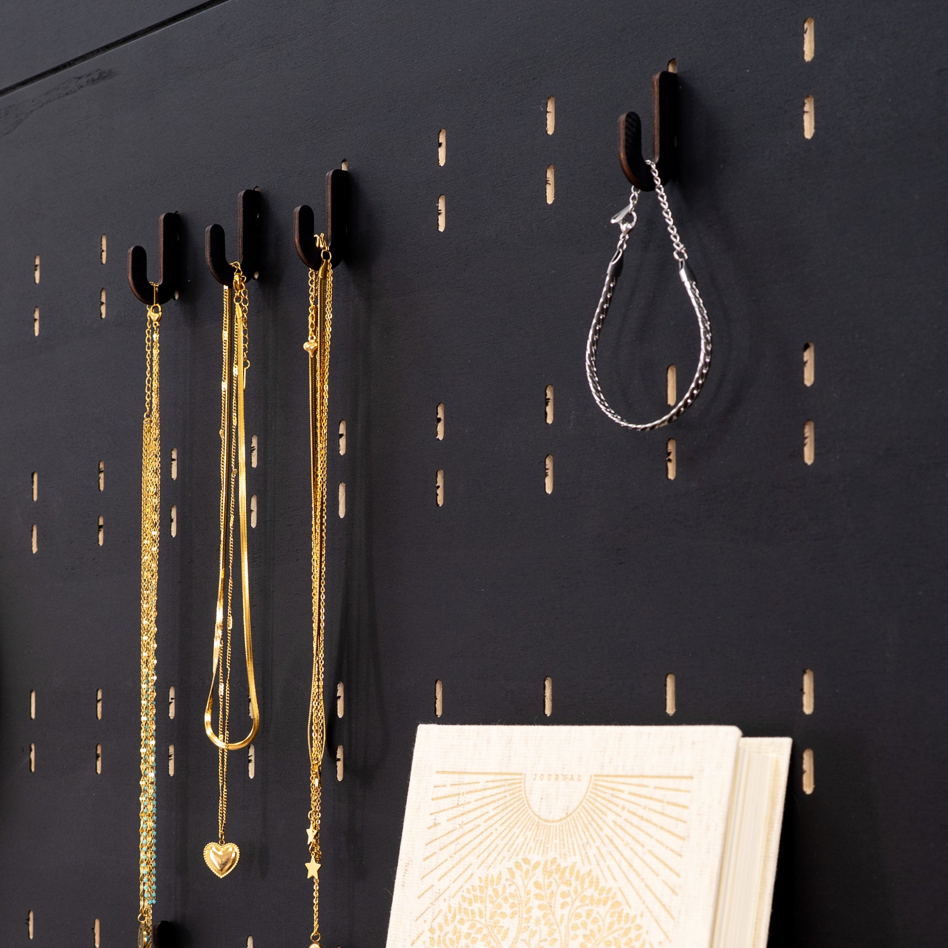 Black short hooks for pegboards, offering an efficient and stylish way to organize and showcase products, accessories, and merchandise.