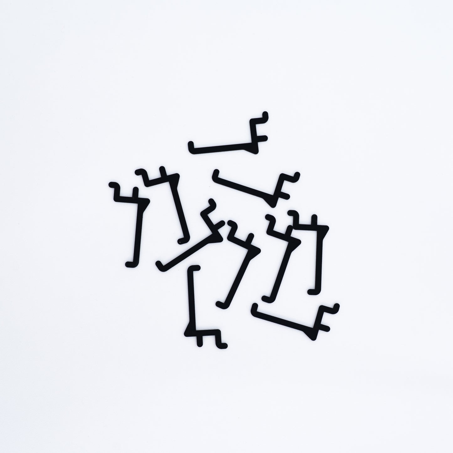 Set of 10 long hooks in black for pegboards, ideal for displaying items such as clothing, accessories, and bags.