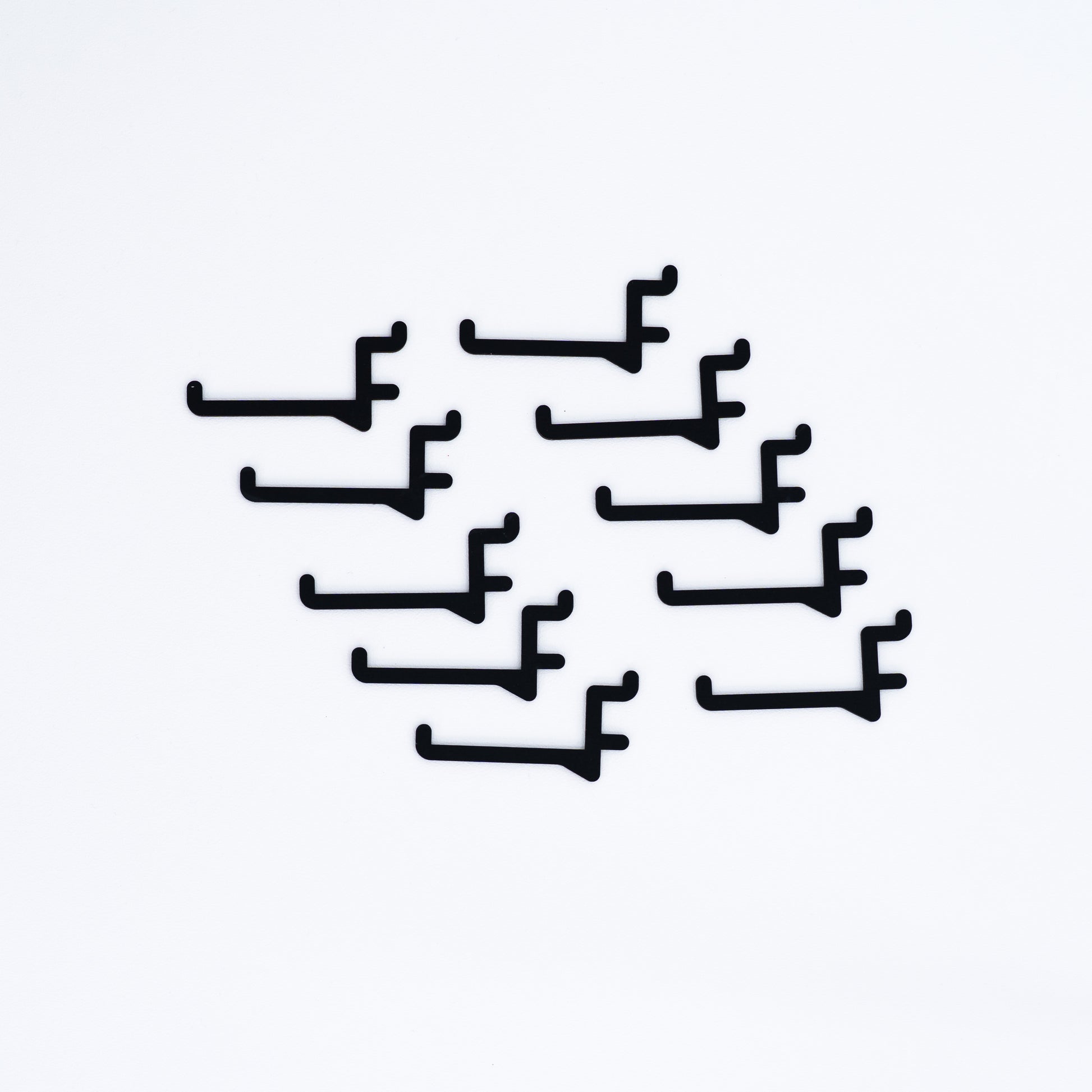 Black long hooks for pegboards, offering an elegant and versatile way to display items at pop-up events, exhibitions, and retail shops.