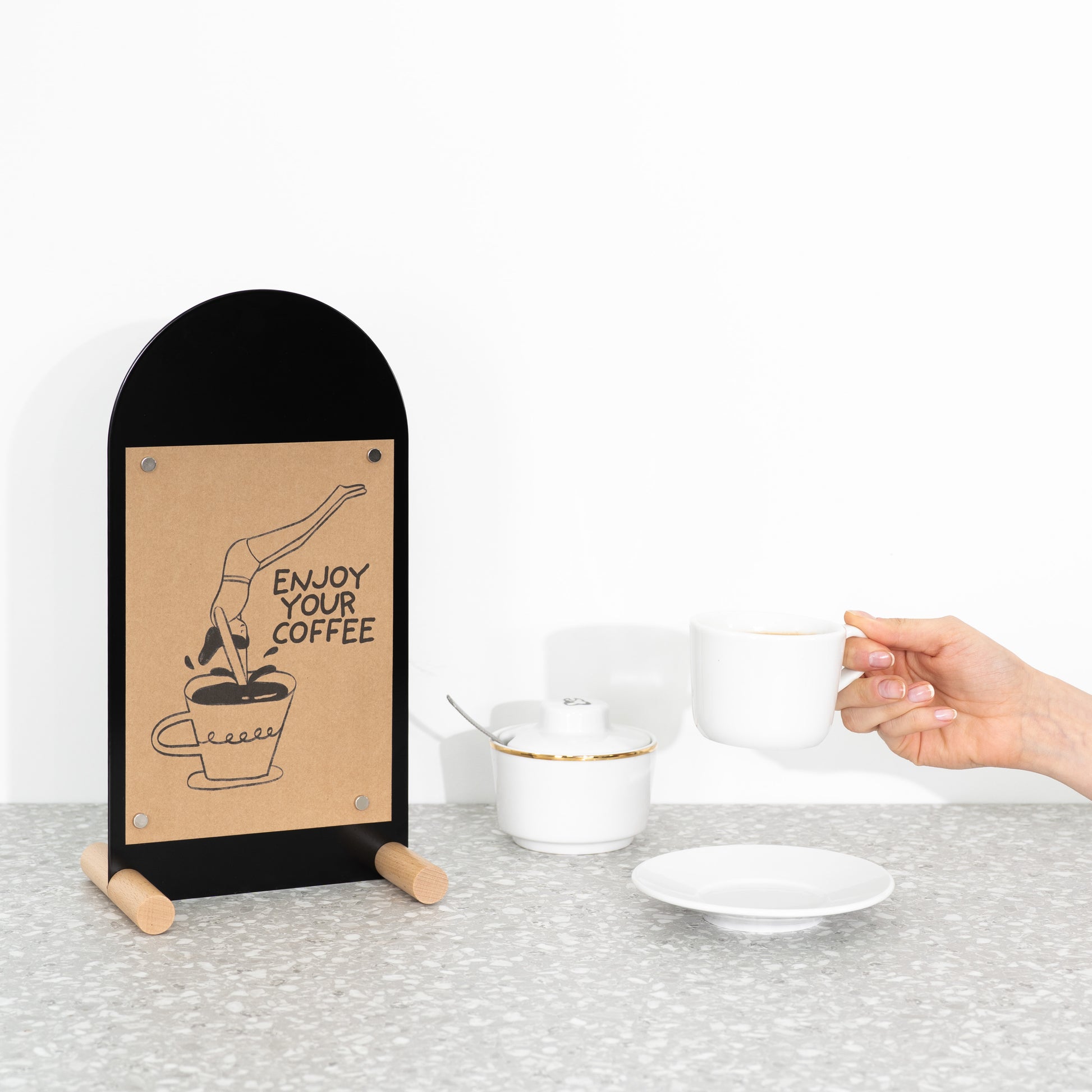 Modern tabletop signage solution with writable black front and warm wood legs