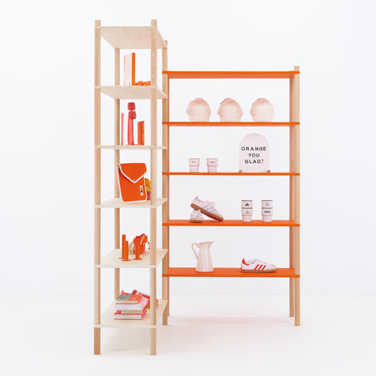 Corner display shelf with customizable orange shelves in retail booth setup