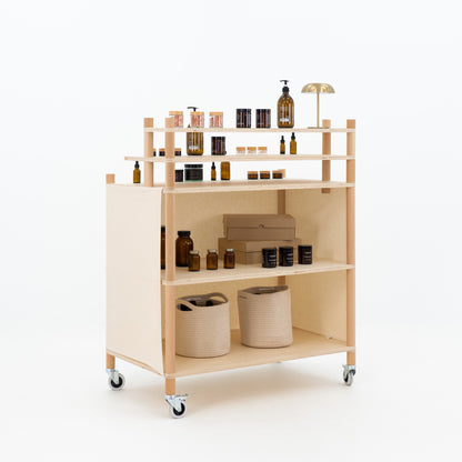 Back view of checkout counter showing open storage shelves for inventory
