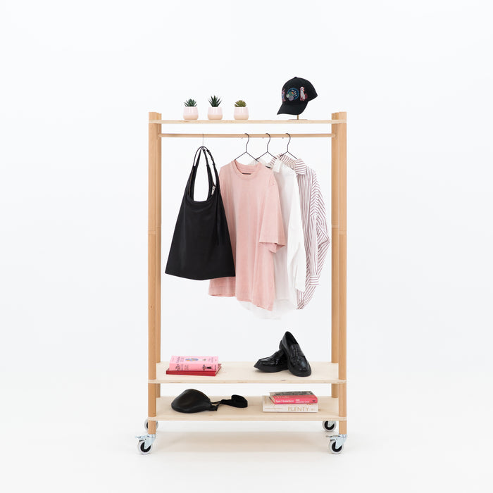 BAMBUK Compact Garment Rack showcasing clothing and accessories at a pop-up event

