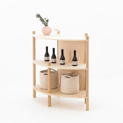 back view of bambuk concave checkout counter with natural plywood panel
