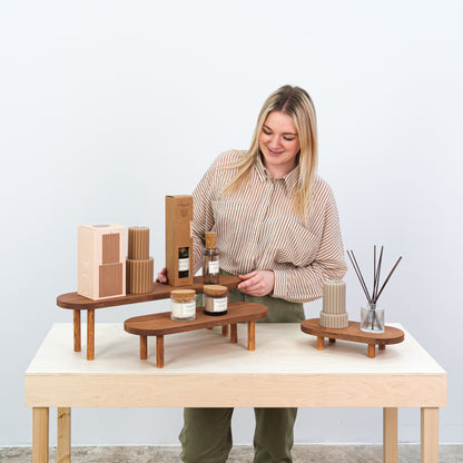 Compact coffee-colored display risers for pop-up shops and salons

