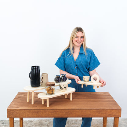 Foldable wooden display risers arranged in three tiers

