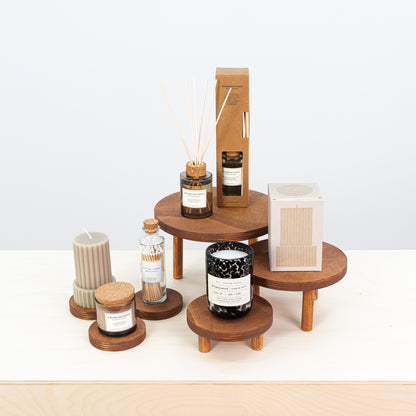 set of 3 wooden risers with matching coasters for product display

