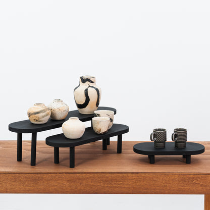 Foldable black wooden risers in three sizes for craft fairs

