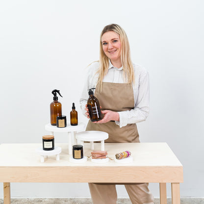foldable white plywood risers for candles and skincare products

