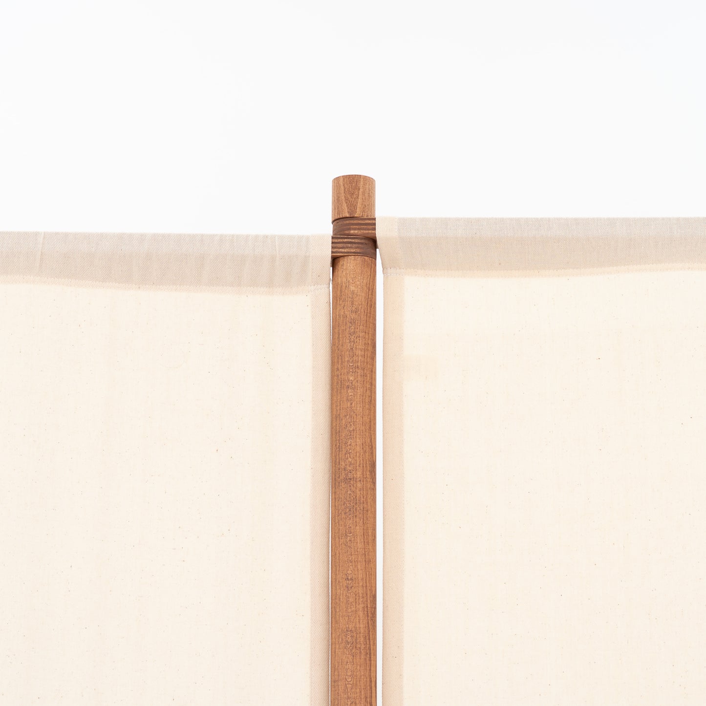 Warm natural fabric event wall detail for boutique product displays