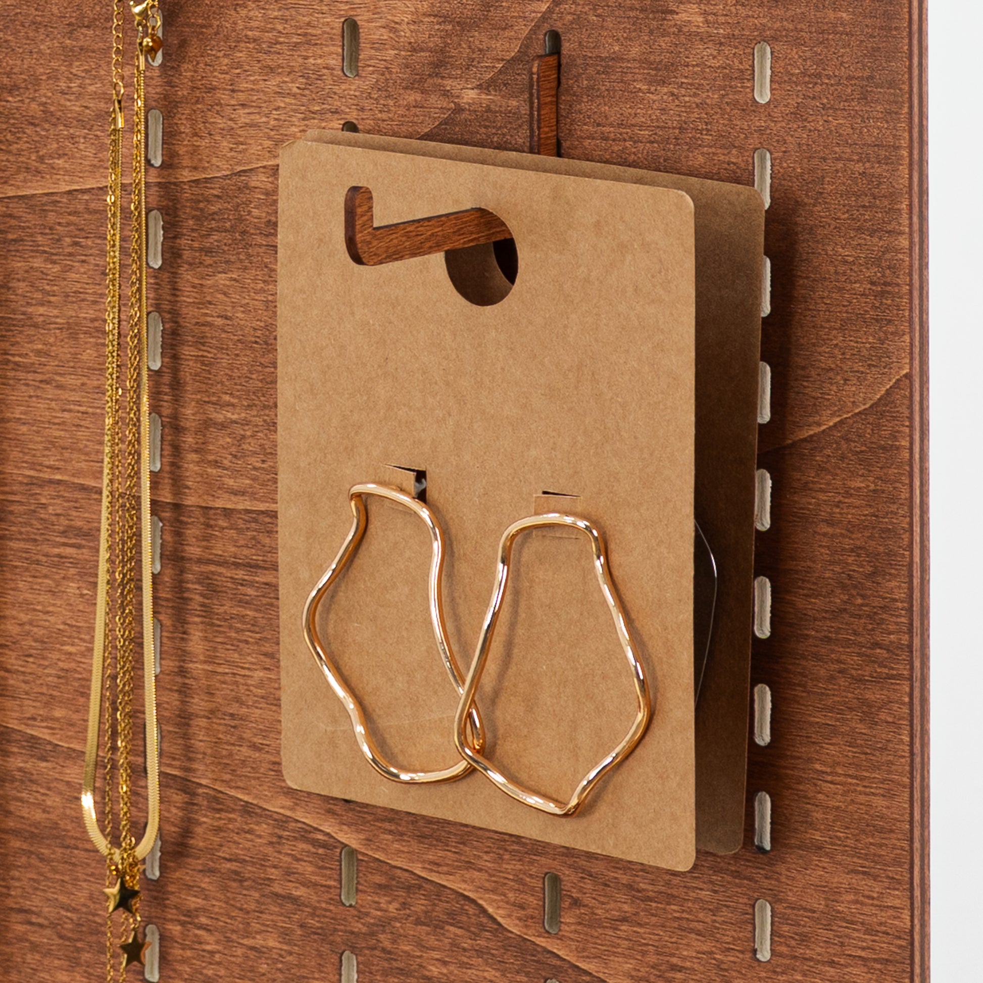 Pack of 10 long hooks in Coffe color, crafted from durable plywood for stylish and versatile pegboard displays.