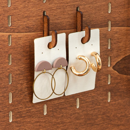 Pack of 10 short hooks in warm Coffe color, designed for freestanding and tabletop pegboards to showcase a variety of products.