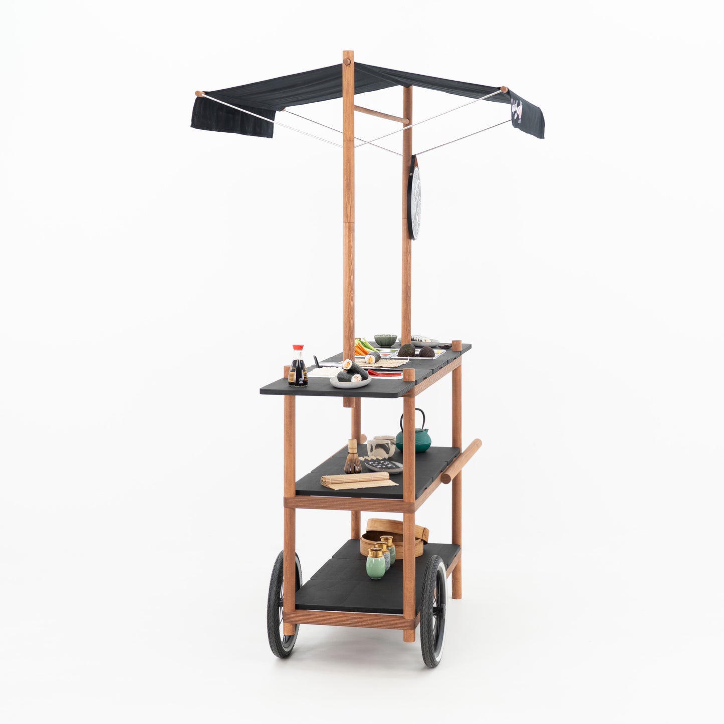 Side view of the BC-09-W-ML mobile cart with canopy and round logo board at a sushi pop-up