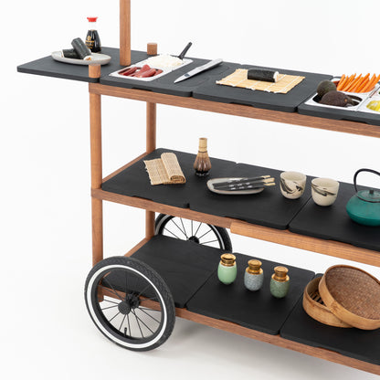 Three-tier layout of the BC-09-W-ML event cart with black countertops, spoked wheel and sushi serving props