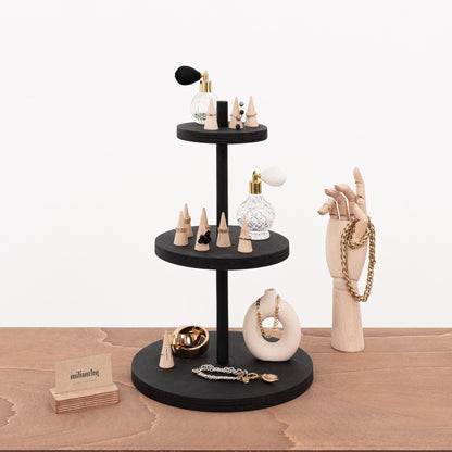 Elegant display stand with three tiers for retail environments, perfect for organizing small luxury items.