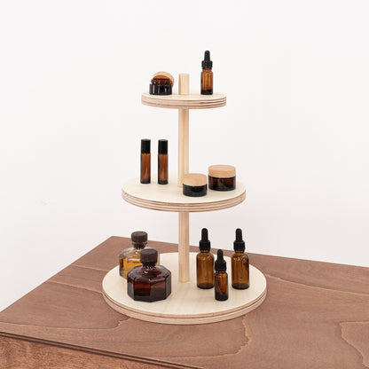 A clean and minimalistic natural wood display riser, perfect for organizing cosmetics and fragrances in retail or event setups.