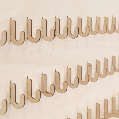 Set of 10 short hooks for pegboards, designed for organizing small products and accessories in retail and event displays.