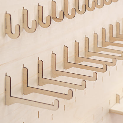 Pack of 10 long hooks for pegboards, offering an elegant and practical solution for showcasing large items like apparel and decor.