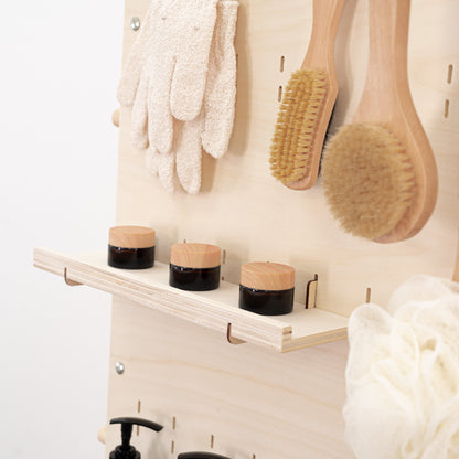Functional and modern natural wood pegboard stand with storage and customizable branding for retail environments.