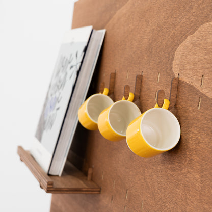 Close-up of coffee-colored pegboard stand with adjustable shelves, perfect for organizing and displaying products at trade shows.