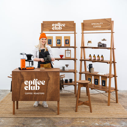 Coffee wood display booth with shelving and counter
