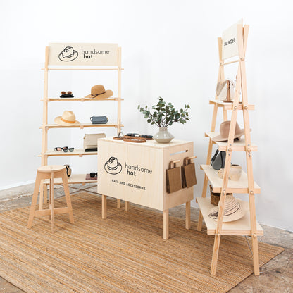 Wooden trade fair furniture with risers and pegboard

